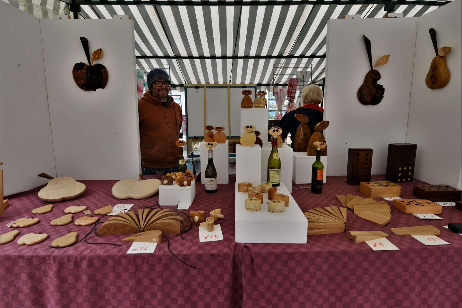 Wooden handcrafted goods displayed on a market stall at the bank holiday street fair on North Street in Winchcombe, Gloucestershire