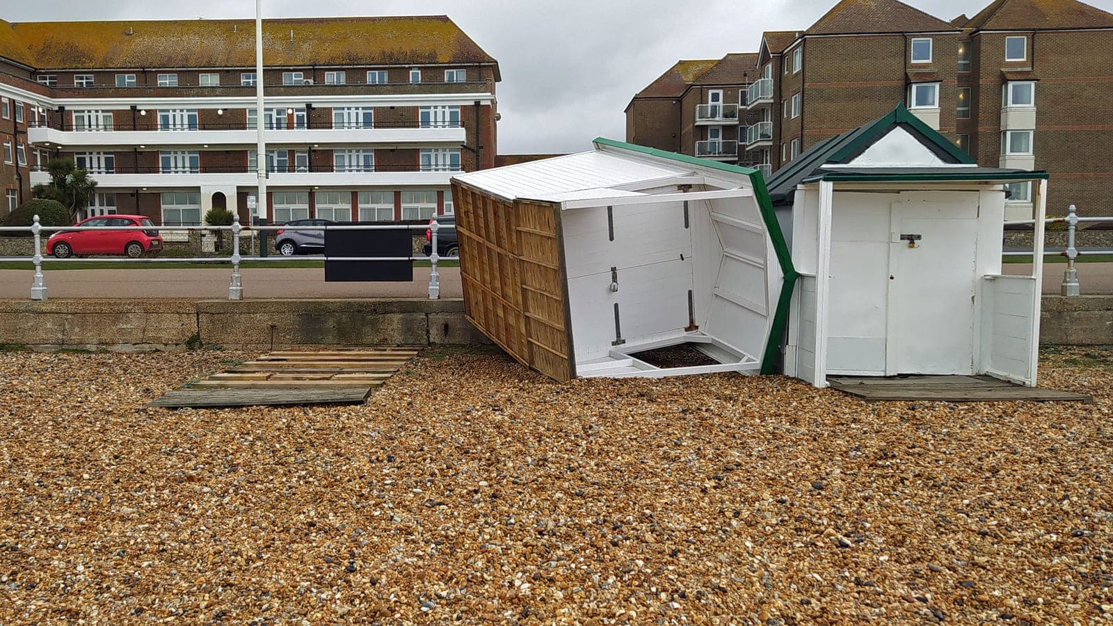 A beach hut toppled onto its side on East Parade at Bexhill-on-Sea after Storm Eunice hit the Sussex coast.